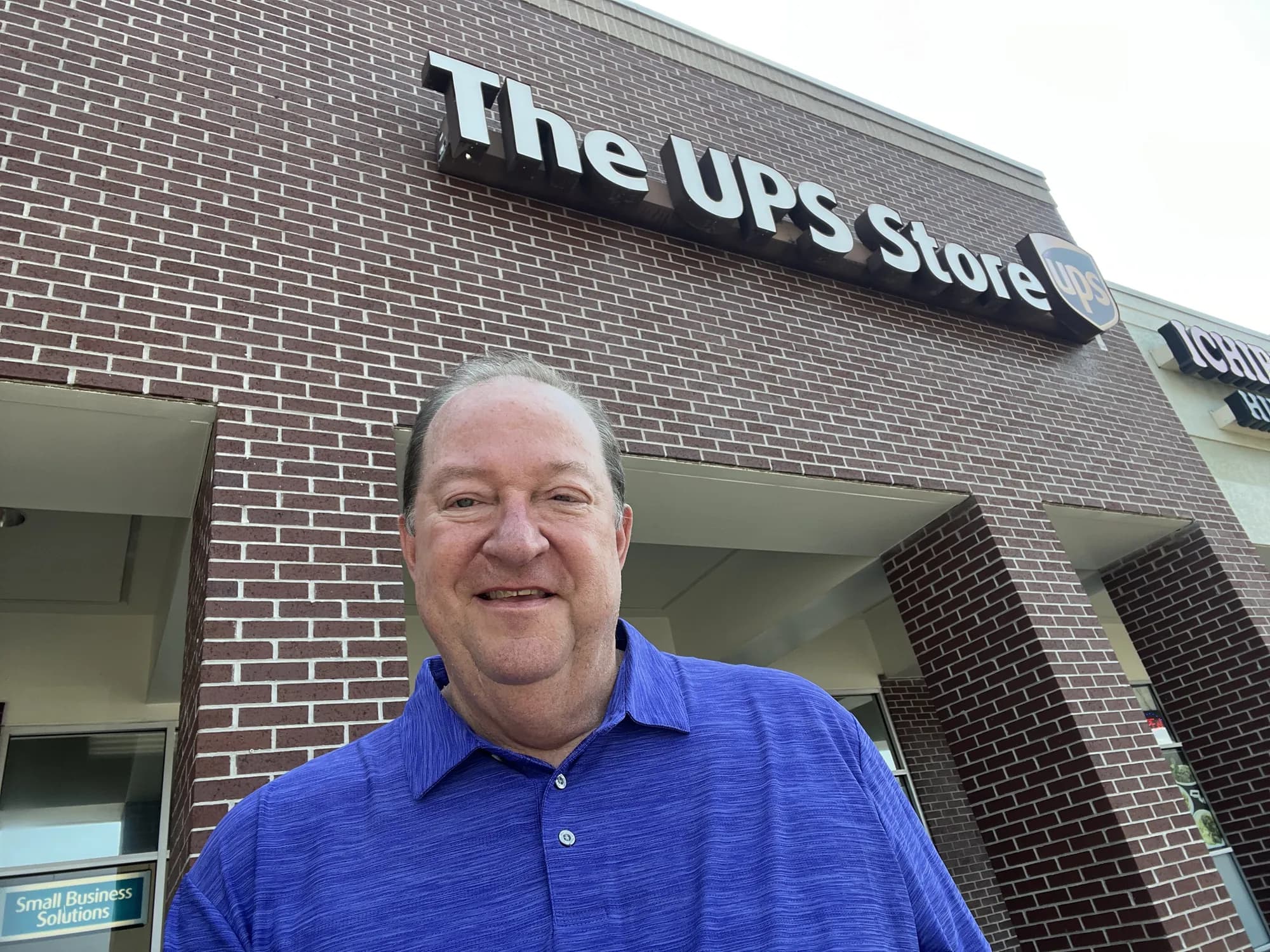 Jim McElroy standing beneath The UPS Store sign