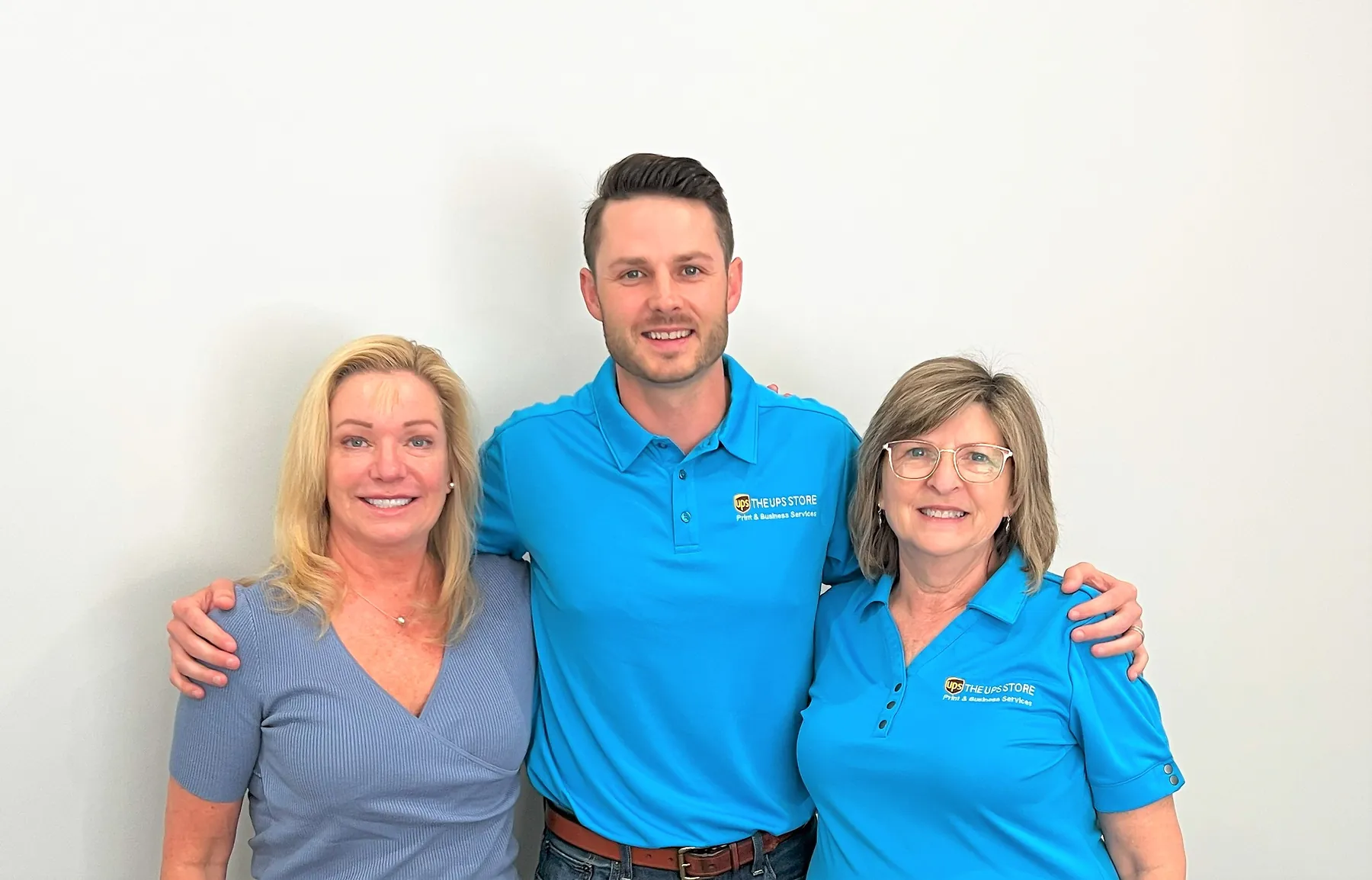 Three team members from The UPS Store together